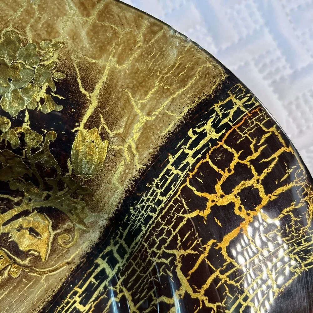 Glass bowl features an asymmetrical shape with a striking black and gold crackle